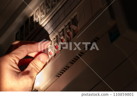 Operate the breaker switch in a dark room 110859801