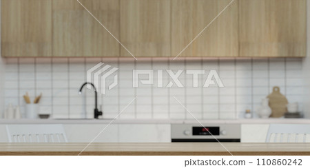 Modern empty wooden table top or kitchen island for montage product display on blurry Scandinavian kitchen room interior background. 3d rendering illustration Modern empty wooden table top or kitchen island for montage product display on blurry Scandinavian kitchen room interior background. 3d rendering illustration 110860242