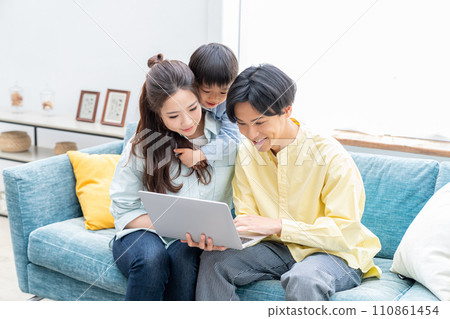 Close family looking at a computer 110861454