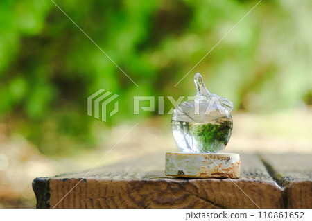 glass apple placed outdoors 110861652
