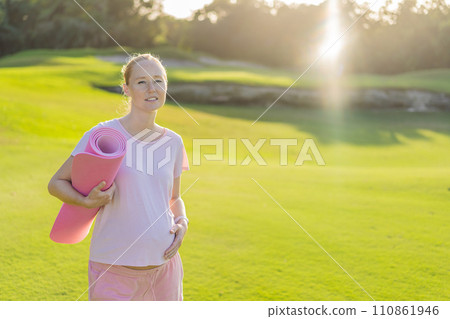 Energetic pregnant woman takes her workout outdoors, using an exercise mat for a refreshing and health-conscious outdoor exercise session Energetic pregnant woman takes her workout outdoors, using an exercise mat for a refreshing and health-conscious outdoor exercise session 110861946