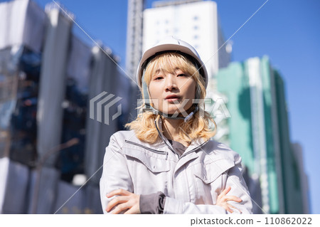 Business Woman in work clothes working at a construction site 110862022