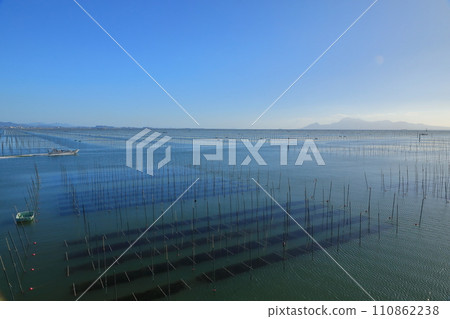 A view of a seaweed farm in the Ariake Sea where a small work boat floats A view of a seaweed farm in the Ariake Sea where a small work boat floats 110862238
