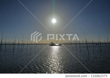 A view of seaweed farming boats in the Ariake Sea shining in the sunlight A view of seaweed farming boats in the Ariake Sea shining in the sunlight 110862373