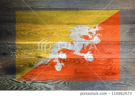 Bhutan flag on rustic old wood surface background Bhutan flag on rustic old wood surface background 110862673