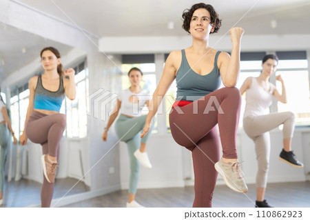 Female teacher conducts modern dance lessons for group of girls Female teacher conducts modern dance lessons for group of girls 110862923