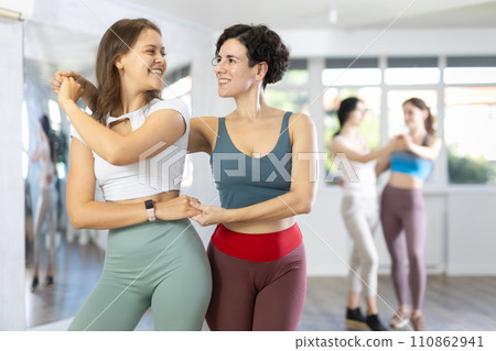 Group of women dancing pair dances in studio 110862941
