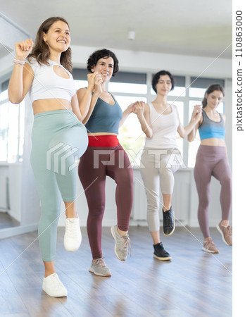 Group of girls with middle-aged woman perform Irish folk dance Group of girls with middle-aged woman perform Irish folk dance 110863000
