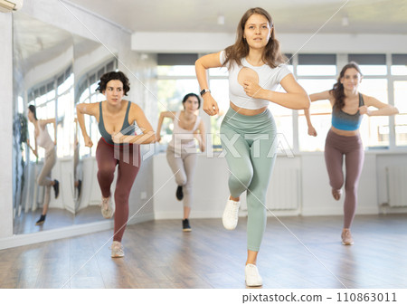 Group of women dancing dancehall in studio Group of women dancing dancehall in studio 110863011