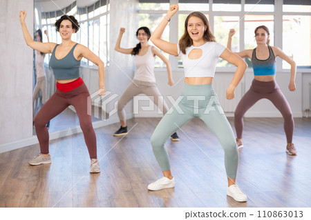 Young female teacher conducts modern hip hop dance lessons for group of girls Young female teacher conducts modern hip hop dance lessons for group of girls 110863013