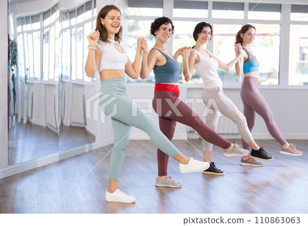 Young girls learn to perform Irish dancing during group classes at fitness center 110863063