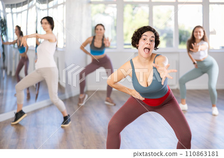 Female teacher conducts modern dance lessons for group of girls Female teacher conducts modern dance lessons for group of girls 110863181