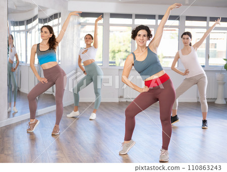 Female teacher conducts modern dance lessons for group of girls 110863243