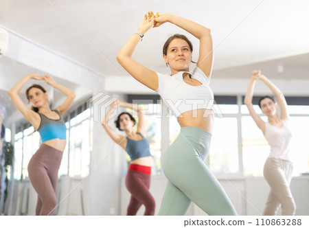 Smiling young girl in dancing passionate flamenco in dance studio Smiling young girl in dancing passionate flamenco in dance studio 110863288