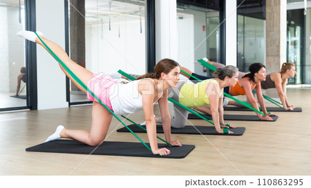 Women doing stretches with resistance band Women doing stretches with resistance band 110863295