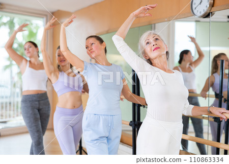 Adults learning to dance ballet in dancing school 110863334