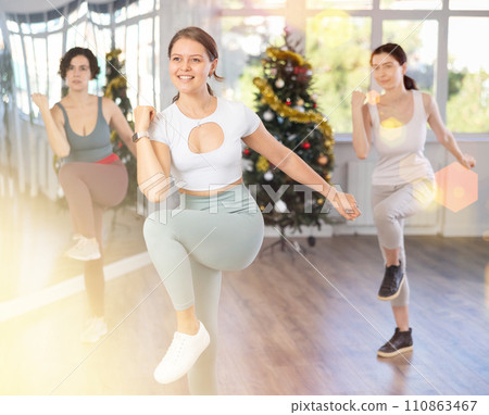 Girl conducts modern dance lessons for group of women during New Year Eve 110863467