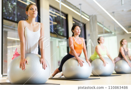 Women of different ages doing upward-facing dog pose Women of different ages doing upward-facing dog pose 110863486