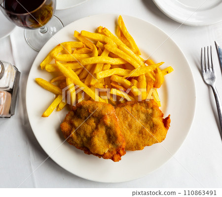 Traditional Spanish dish is goat cheese and pepper booklets with French fries 110863491
