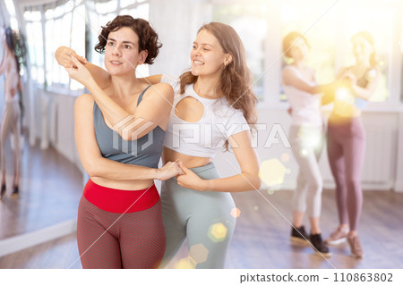 Middle-aged woman and girl are dancing vigorous pair dance in couple 110863802