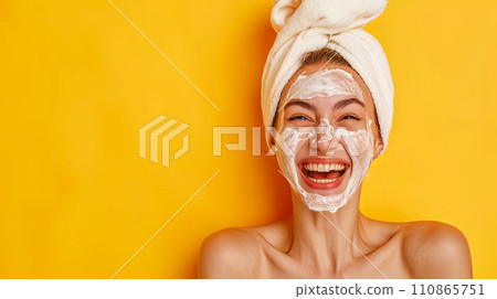 AI-generated content. A woman with a beaming smile, wearing a facial mask and a towel on her head, against a bright yellow background, perfect for a skincare or beauty concept with copy space. AI-generated content. A woman with a beaming smile, wearing a facial mask and a towel on her head, against a bright yellow background, perfect for a skincare or beauty concept with copy space. 110865751