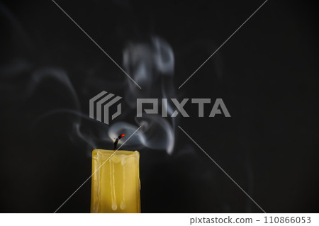 Candle still emitting smoke after the flame has been extinguished Candle still emitting smoke after the flame has been extinguished 110866053