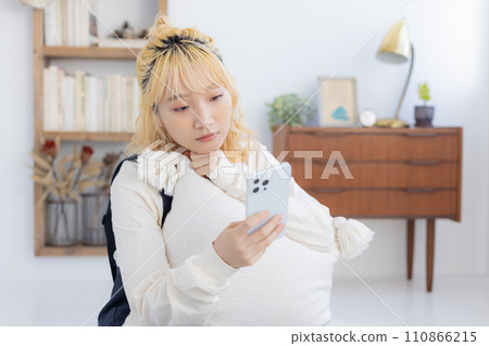 A woman looking at a smartphone A woman looking at a smartphone 110866215