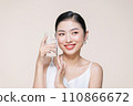 Woman with glass of fresh water in white portrait. 110866672