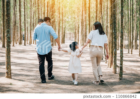 Asian happy family walking through a park in the summer, with the parents holding the hands of their three children, Happy family day Asian happy family walking through a park in the summer, with the parents holding the hands of their three children, Happy family day 110866842