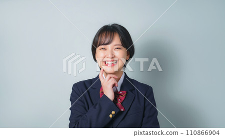 Smiling female student in uniform Smiling female student in uniform 110866904