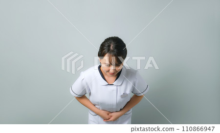 A woman wearing a white coat bowing 110866947