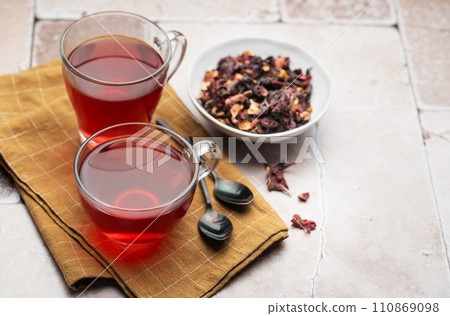 Glass cup of hot hibiscus tea. 110869098