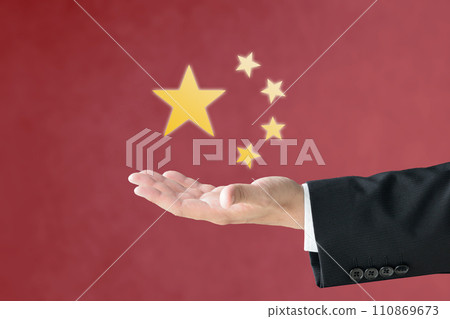 A man's hand holding up the star of the Chinese flag A man's hand holding up the star of the Chinese flag 110869673