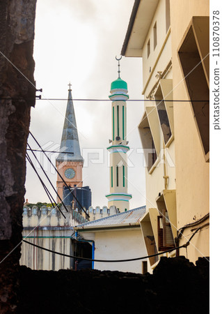 Christian church and minaret of the mosque side by side in Stone Town, Zanzibar, Tanzania Christian church and minaret of the mosque side by side in Stone Town, Zanzibar, Tanzania 110870378