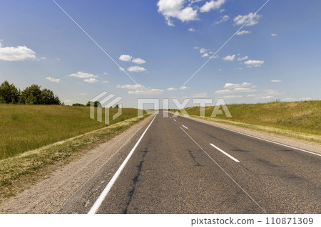 paved road along and blue sky 110871309