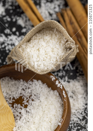 dried coconut shavings on a slate board 110871325