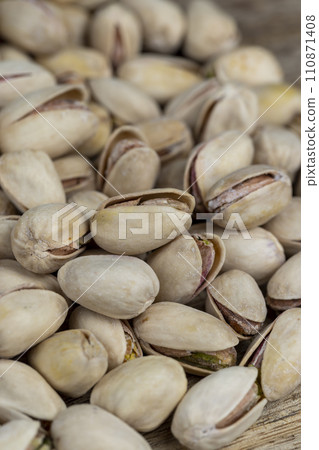 Salted fried pistachios on the table 110871408