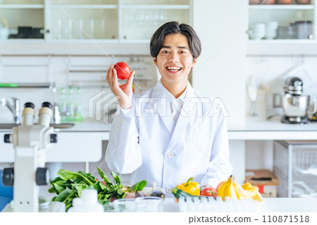 Male researcher showing vegetables and fruits, registered dietitian 110871518