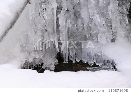 Frozen stream. Beautiful winter nature background. Frost, ice and snow in the winter. Frozen stream. Beautiful winter nature background. Frost, ice and snow in the winter. 110871698