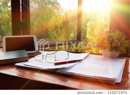 red pen over blurred paperwork for proofreading 110871974