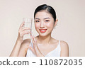 Woman with glass of fresh water in white portrait. 110872035