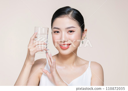 Woman with glass of fresh water in white portrait. Woman with glass of fresh water in white portrait. 110872035