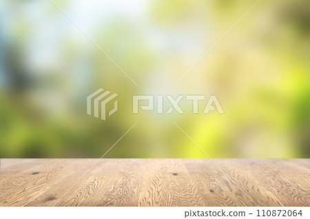 Background image of a wooden table with wood grain with natural green background 110872064