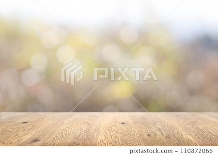 Background image of a wooden table with wood grain with natural green background Background image of a wooden table with wood grain with natural green background 110872066