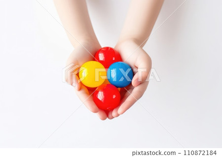 AI generated Child hands holding and playing with colorful plastic balls on white background AI generated Child hands holding and playing with colorful plastic balls on white background 110872184