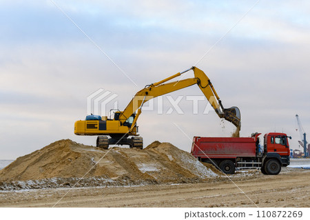 Yellow excavator working on construction site. The road construction. 110872269
