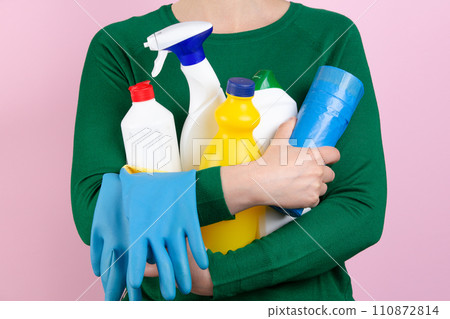 woman with many cleaning products in her arms 110872814