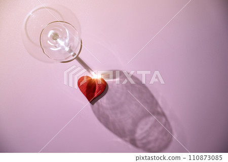 Wine glass with a red heart 110873085