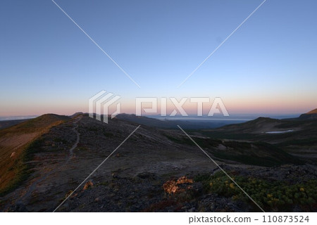 Mountain trail illuminated by the morning sun 110873524