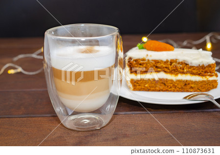 Carrot sponge cake with cream and walnuts and Cappuccino coffee 110873631